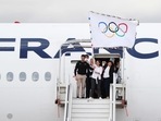 French Olympic medallists arrive with the Olympic flag in Paris