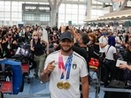 Tokyo: Lamont Marcell Jacobs of Italy shows the gold medals he won in the men's 100mt and 4x100 relay as he checks in at the Tokyo Haneda airport on his way back to Italy at the end of 2020 Summer Olympics, Monday, Aug. 2, 2021, in Tokyo, Japan. AP/PTI Photo(AP08_09_2021_000016B)(AP) Tokyo: Lamont Marcell Jacobs of Italy shows the gold medals he won in the men's 100mt and 4x100 relay as he checks in at the Tokyo Haneda airport on his way back to Italy at the end of 2020 Summer Olympics, Monday, Aug. 2, 2021, in Tokyo, Japan. AP/PTI Photo(AP08_09_2021_000016B)(AP)