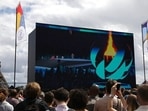 Spectators watch the closing ceremony of the Tokyo 2020 Olympic Games on a big screen at the Olympics fan zone in Trocadero Gardens in Paris, Sunday, Aug. 8, 2021. Celebrations were held in Paris Sunday as part of the handover ceremony of Tokyo 2020 to Paris 2024, as Paris will be the next Summer Games host in 2024. The passing of the hosting baton will be split between the Olympic Stadium in Tokyo and a public party and concert in Paris. (AP Photo/Adrienne Surprenant)
