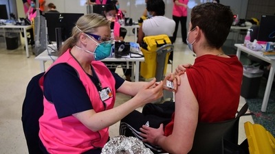 Students receive their first dose of the Pfizer Covid-19 vaccine in Sydney. (AFP) Students receive their first dose of the Pfizer Covid-19 vaccine in Sydney. (AFP)