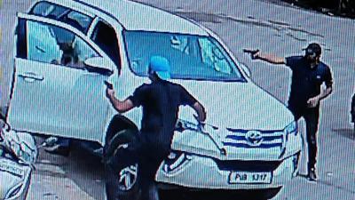 Two of the four attackers had chased and fired at Vicky repeatedly as he was about to sit in his SUV in Sector 71, Mohali, on Saturday. (from CCTV footage) Two of the four attackers had chased and fired at Vicky repeatedly as he was about to sit in his SUV in Sector 71, Mohali, on Saturday. (from CCTV footage)