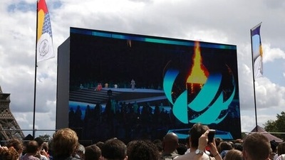 Spectators watch the closing ceremony of the Tokyo 2020 Olympic Games on a big screen at the Olympics fan zone in Trocadero Gardens in Paris, Sunday, Aug. 8, 2021. Celebrations were held in Paris Sunday as part of the handover ceremony of Tokyo 2020 to Paris 2024, as Paris will be the next Summer Games host in 2024. The passing of the hosting baton will be split between the Olympic Stadium in Tokyo and a public party and concert in Paris. (AP Photo/Adrienne Surprenant) (AP) Spectators watch the closing ceremony of the Tokyo 2020 Olympic Games on a big screen at the Olympics fan zone in Trocadero Gardens in Paris, Sunday, Aug. 8, 2021. Celebrations were held in Paris Sunday as part of the handover ceremony of Tokyo 2020 to Paris 2024, as Paris will be the next Summer Games host in 2024. The passing of the hosting baton will be split between the Olympic Stadium in Tokyo and a public party and concert in Paris. (AP Photo/Adrienne Surprenant) (AP)