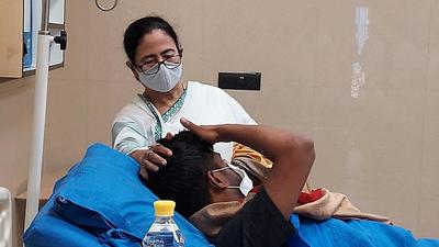 West Bengal chief minister Mamata Banerjee meets a TMC worker who was injured in Tripura, at SSKM Hospital in Kolkata on Monday. (ANI) West Bengal chief minister Mamata Banerjee meets a TMC worker who was injured in Tripura, at SSKM Hospital in Kolkata on Monday. (ANI)