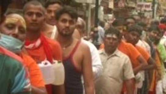 People were seen without face masks and blatantly flouting social distancing norms while waiting in the queue.(ANI/Twitter)