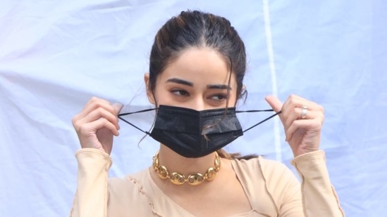 Ananya Pandey pulling off her mask for pictures.