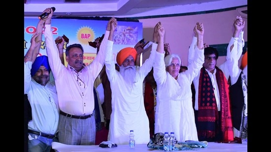 BKU leader Gurnam Singh Charuni (orange Turban) with members of trading community at the launch of Bhartiya Arthik Party ahead in Ludhiana on Monday. (Harsimar Pal Singh/HT)