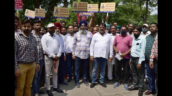 MC employees gathered outside the Ludhiana mayor’s camp office against the transfer MC secretary Jasdev Sekhon on Monday. (Gurpreet Singh/HT)