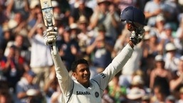 Anil Kumble with his bat in the air like he just doesn't care.