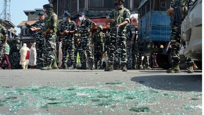 Security personnel cordon off the area and inspect the site of a grenade attack at Hari Singh High Street in Srinagar on Tuesday. (PTI Photo) Security personnel cordon off the area and inspect the site of a grenade attack at Hari Singh High Street in Srinagar on Tuesday. (PTI Photo)