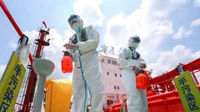 Police officers wearing protective gear against the spread of Covid-19 spray disinfectant at Nanjing port in China's eastern Jiangsu province. (AFP) Police officers wearing protective gear against the spread of Covid-19 spray disinfectant at Nanjing port in China's eastern Jiangsu province. (AFP)