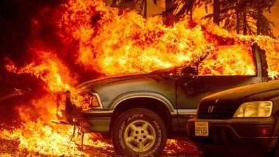 Vehicles engulfed in flames as the Dixie fire rages on in Greenville, California. (AFP)