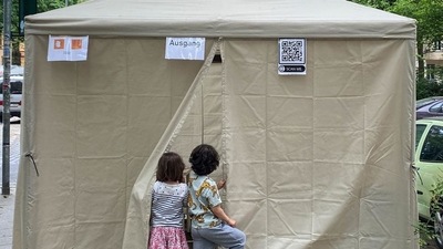 Two children look inside a tent where a parent tests for the coronavirus (Covid-19) in Berlin's Kreuzberg district. (AFP file photo) Two children look inside a tent where a parent tests for the coronavirus (Covid-19) in Berlin's Kreuzberg district. (AFP file photo)
