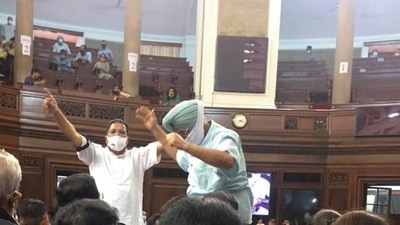 Congress MPs Partap Singh Bajwa and Ripun Bora protest inside the Rajya Sabha after opposition was not allowed to discuss on farmers issue, during the Monsoon Session of Parliament, in New Delhi. (PTI Photo) Congress MPs Partap Singh Bajwa and Ripun Bora protest inside the Rajya Sabha after opposition was not allowed to discuss on farmers issue, during the Monsoon Session of Parliament, in New Delhi. (PTI Photo)