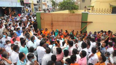 AIADMK party members block the road and demanding the officials of Diroctorate of Vigilance and Anti Corruption (DVAC) to return back from the party MLA SP Velumani's house at Sugunapuram, Kuniyamuthur in Coimbatore on Tuesday. (PTI) AIADMK party members block the road and demanding the officials of Diroctorate of Vigilance and Anti Corruption (DVAC) to return back from the party MLA SP Velumani's house at Sugunapuram, Kuniyamuthur in Coimbatore on Tuesday. (PTI)