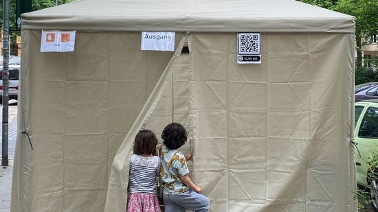 Two children look inside a tent where a parent tests for the coronavirus (Covid-19) in Berlin's Kreuzberg district. (AFP file photo)