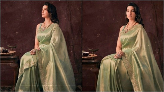 Nora Fatehi goes all traditional as she styles herself in a shiny green saree with gold borders. She accessorised her look with a pearl neckpiece and stone ring.(Instagram/@norafatehi)