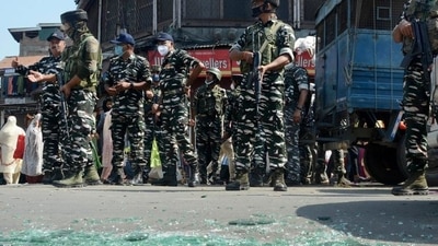Security personnel cordon off the area and inspect the site of a grenade attack at Hari Singh High Street in Srinagar. (PTI Photo)