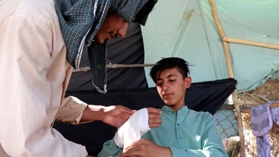 An Afghan youth receives medical care after being injured in fighting between the Taliban and Afghan security forces, in Mazar-e-Sharif, on Tuesday. (AP Photo) An Afghan youth receives medical care after being injured in fighting between the Taliban and Afghan security forces, in Mazar-e-Sharif, on Tuesday. (AP Photo)