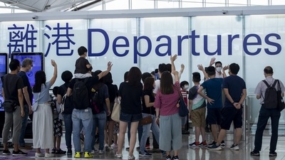 Family and friends see off travellers in the departures hall at Hong Kong International Airport in Hong Kong, China. (Bloomberg)