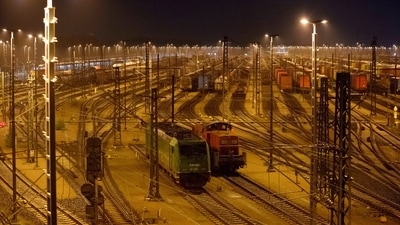 Locomotives and freight wagons stand at the Maschen freight station, on Tuesday night, Aug. 10, 2021, in Maschen, Germany. (Jonas Walzberg / AP)