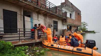 National Disaster Response Force team evacuating people from a flood-affected area at Salori in Prayagraj district of Uttar Pradesh on Wednesday. (PTI PHOTO) National Disaster Response Force team evacuating people from a flood-affected area at Salori in Prayagraj district of Uttar Pradesh on Wednesday. (PTI PHOTO)