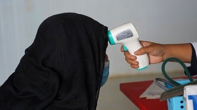 A health official checks the temperature of a Rohingya refugee in Cox's Bazar, Bangladesh, on Tuesday. (AP Photo)