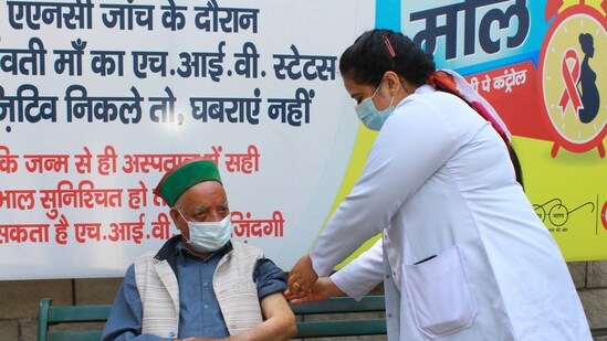 A healthcare worker administers a dose of Covid-19 vaccine to a beneficiary in Kullu, Himachal Pradesh, on Tuesday.(Aqil Khan/HT Photo)