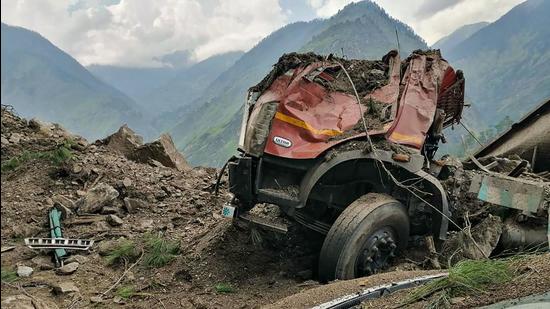 The mangled remains of a vehicle that was buried under the debris on the Reckong Peo-Shimla Highway in Kinnaur district on Wednesday. (PTI)