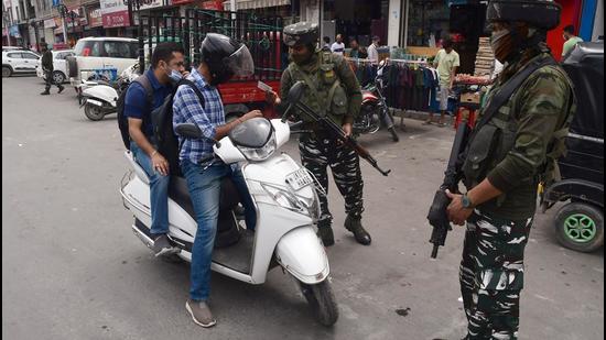 Security personnel check the ID of a vehicle in Srinagar. (Representational image/ANI)