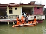 NDRF personnel evacuate residents from inundated houses following the flooding of River Ganga, in Prayagraj, Uttar Pradesh, on Thursday.(AP Photo) NDRF personnel evacuate residents from inundated houses following the flooding of River Ganga, in Prayagraj, Uttar Pradesh, on Thursday.(AP Photo)