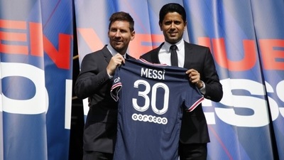 Paris St Germain's Lionel Messi and president Nasser Al-Khelaifi pose with a shirt on the pitch. (REUTERS)