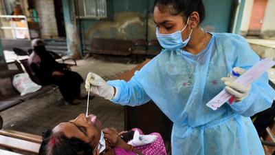 A BMC health worker collects swab samples for Covid test of a citizen at Kherwadi BMC Hospital, in Bandra (East). (Satish Bate/HT PHOTO)