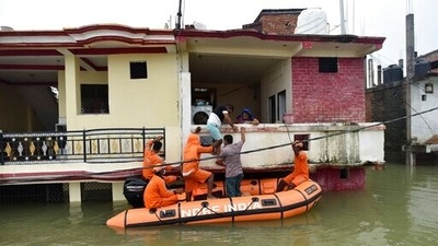 NDRF personnel evacuate residents from inundated houses following the flooding of River Ganga, in Prayagraj, Uttar Pradesh, on Thursday. (AP Photo) NDRF personnel evacuate residents from inundated houses following the flooding of River Ganga, in Prayagraj, Uttar Pradesh, on Thursday. (AP Photo)