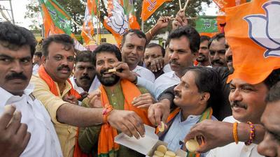MLA CT Ravi being offered sweet by BJP supporters after the party won in 12 out of 15 assembly constituencies of Karnataka, in Chikmagalur in 2019. (PTI)