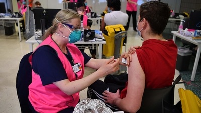Students receive their first dose of the Pfizer Covid-19 vaccine in Sydney. (AFP) Students receive their first dose of the Pfizer Covid-19 vaccine in Sydney. (AFP)