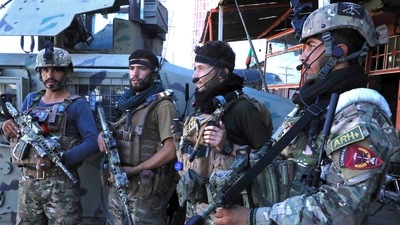 Afghan security force personnel stand guard along the roadside in Herat on August 12, 2021, as Taliban took over the police headquarters in Herat, Afghanistan's third-largest city and also seized another key district capital just 150 kilometres (95 miles) from capital Kabul. (AFP)