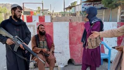 Taliban fighters stand guard at a check point in Farah, Afghanistan. (Reuters)