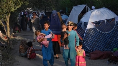 Internally-displaced Afghan families, who fled from Kunduz, Takhar and Baghlan province due to battles between Taliban and Afghan security forces, walk past their temporary tents in Kabul on August 11. (AFP Photo) Internally-displaced Afghan families, who fled from Kunduz, Takhar and Baghlan province due to battles between Taliban and Afghan security forces, walk past their temporary tents in Kabul on August 11. (AFP Photo)