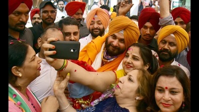 Party workers taking a selfie with Punjab Congress president Navjot Singh Sidhu in Amritsar. Party workers taking a selfie with Punjab Congress president Navjot Singh Sidhu in Amritsar.