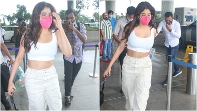 Janhvi chose an all-white airport look for her flight out of Mumbai today. The 'Gunjan Saxena: The Kargil Girl' actor flaunted her toned abs and wore a trendy sleeveless crop top with cargo pants featuring multiple pockets. She teamed a pink face mask with her outfit. (Varinder Chawla) Janhvi chose an all-white airport look for her flight out of Mumbai today. The 'Gunjan Saxena: The Kargil Girl' actor flaunted her toned abs and wore a trendy sleeveless crop top with cargo pants featuring multiple pockets. She teamed a pink face mask with her outfit. (Varinder Chawla)