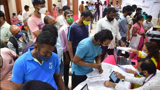 Beneficiaries wait in queue to get vaccinated during a mass vaccination drive, at Byculla, in Mumbai on Thursday. (Bhushan Koyande/ HT Photo)
