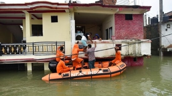 National Disaster Response Force personnel evacuate residents from inundated houses following the flooding of River Ganges, in Prayagraj, Uttar Pradesh on August 12. (AP)