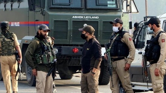Jammu and Kashmir Police stand guard at an encounter site in Kulgam. (ANI)