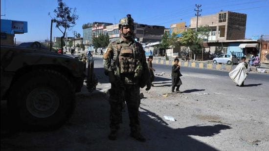 An Afghan security personnel stands guard along the roadside in Herat on Thursday as the Taliban took over the police headquarters in Herat, Afghanistan's third-largest city and also seized another key district capital just 150 kilometres from capital Kabul. (AFP PHOTO.)