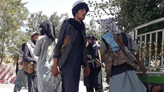 Taliban fighters stand along the roadside in Ghazni on August 12, 2021.&nbsp;(AFP Photo)