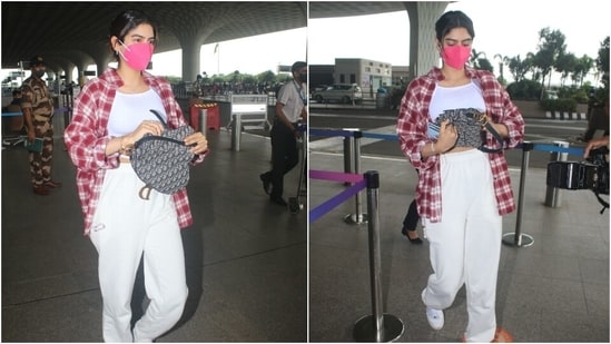 Khushi opted for a white strappy crop top with gathered sides and matching comfy joggers. She layered her ensemble with a checkered, oversized boyfriend shirt, which she left open on the front. (Varinder Chawla)