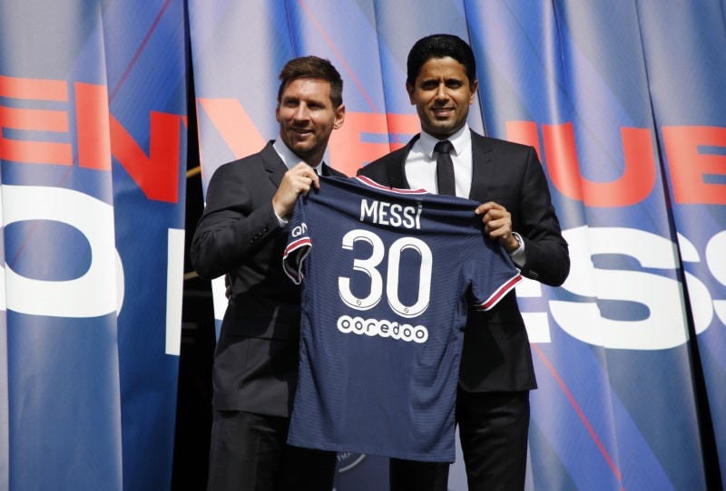 Paris St Germain's Lionel Messi and president Nasser Al-Khelaifi pose with a shirt on the pitch. (REUTERS)