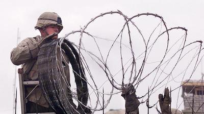 In this file photo, a US Marine uses barbed wire to secure the walls of the US embassy in Kabul. (AFP) In this file photo, a US Marine uses barbed wire to secure the walls of the US embassy in Kabul. (AFP)
