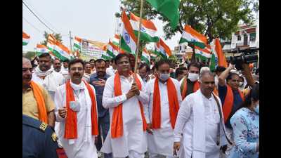 BJP leaders and party workers, carrying the Tricolour, took out a foot-march from the new grain market and covered markets and residential areas of Gharaunda. (HT Photo)