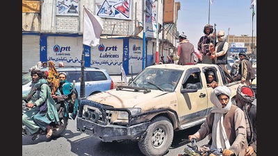 Taliban members drive an Afghan National Army vehicle, in Kandahar on Friday. (AFP) Taliban members drive an Afghan National Army vehicle, in Kandahar on Friday. (AFP)